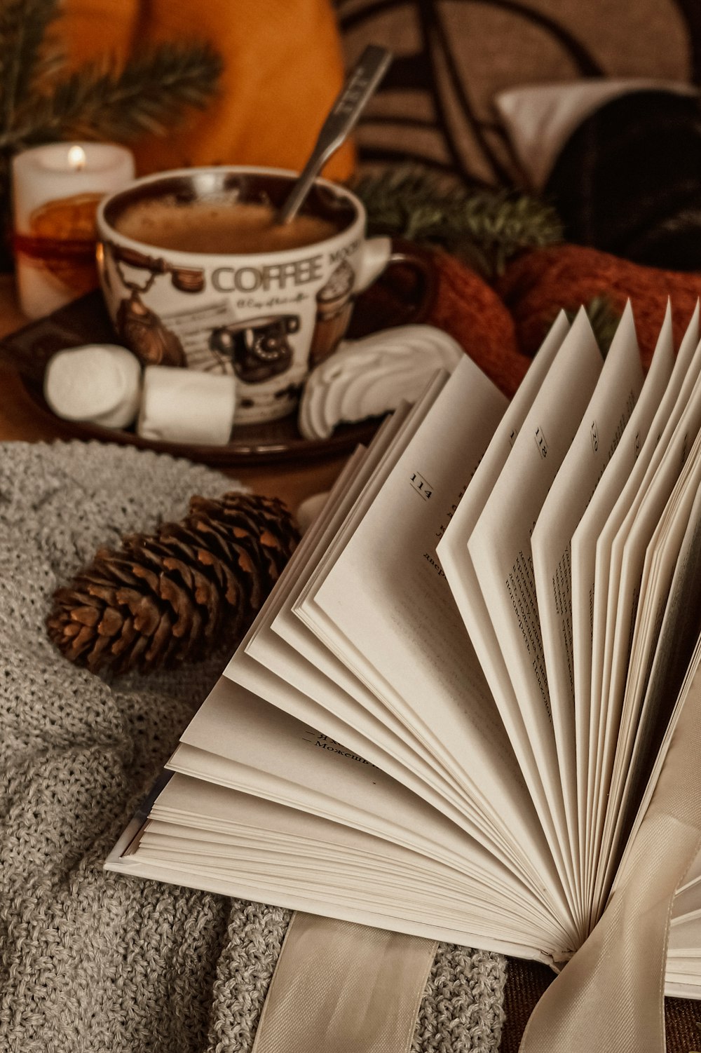 white book on brown and white ceramic mug