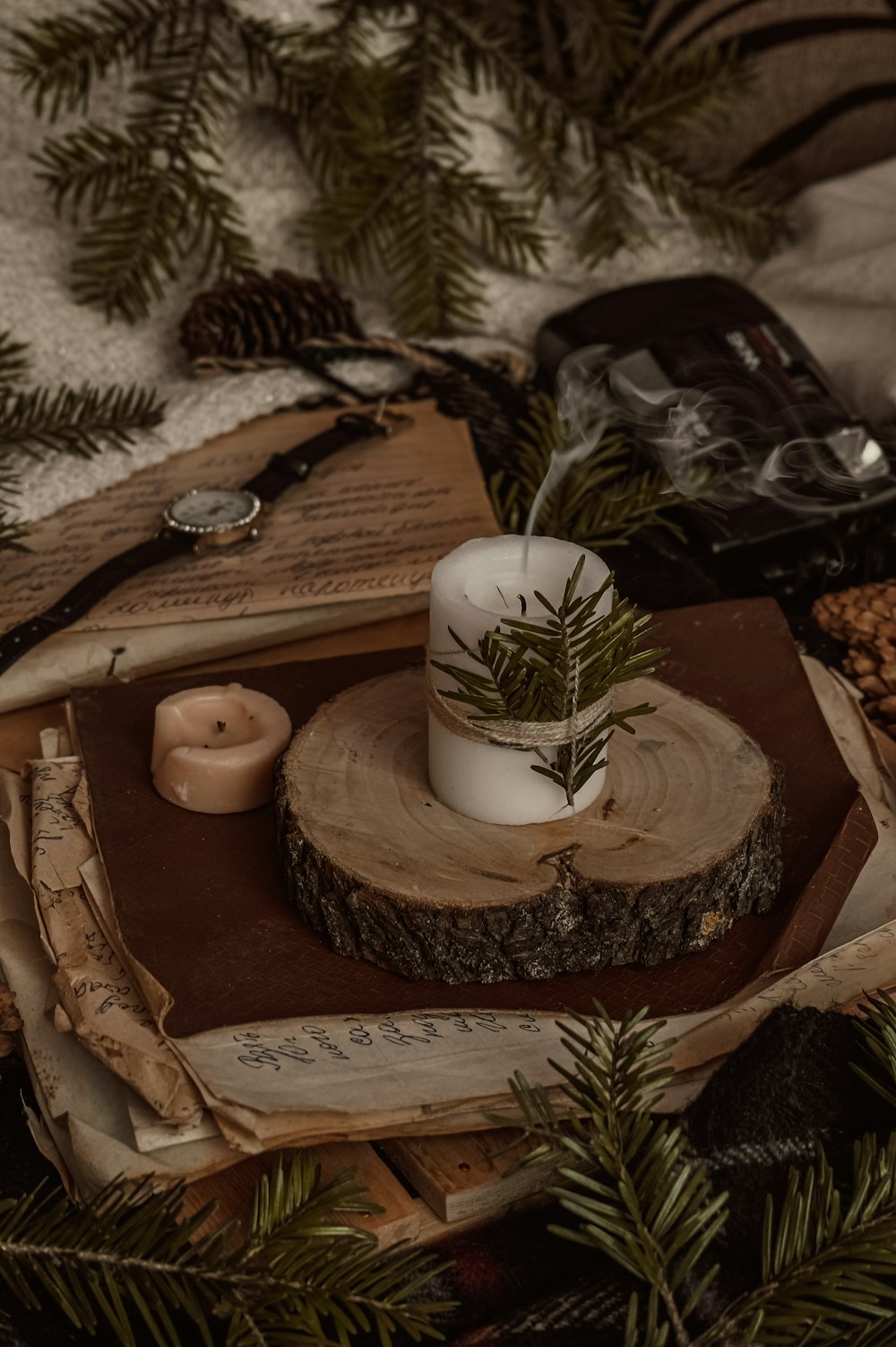 white pillar candle on brown wooden tray