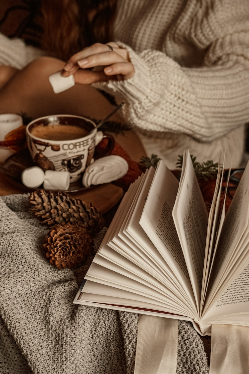 person holding white and brown ceramic mug