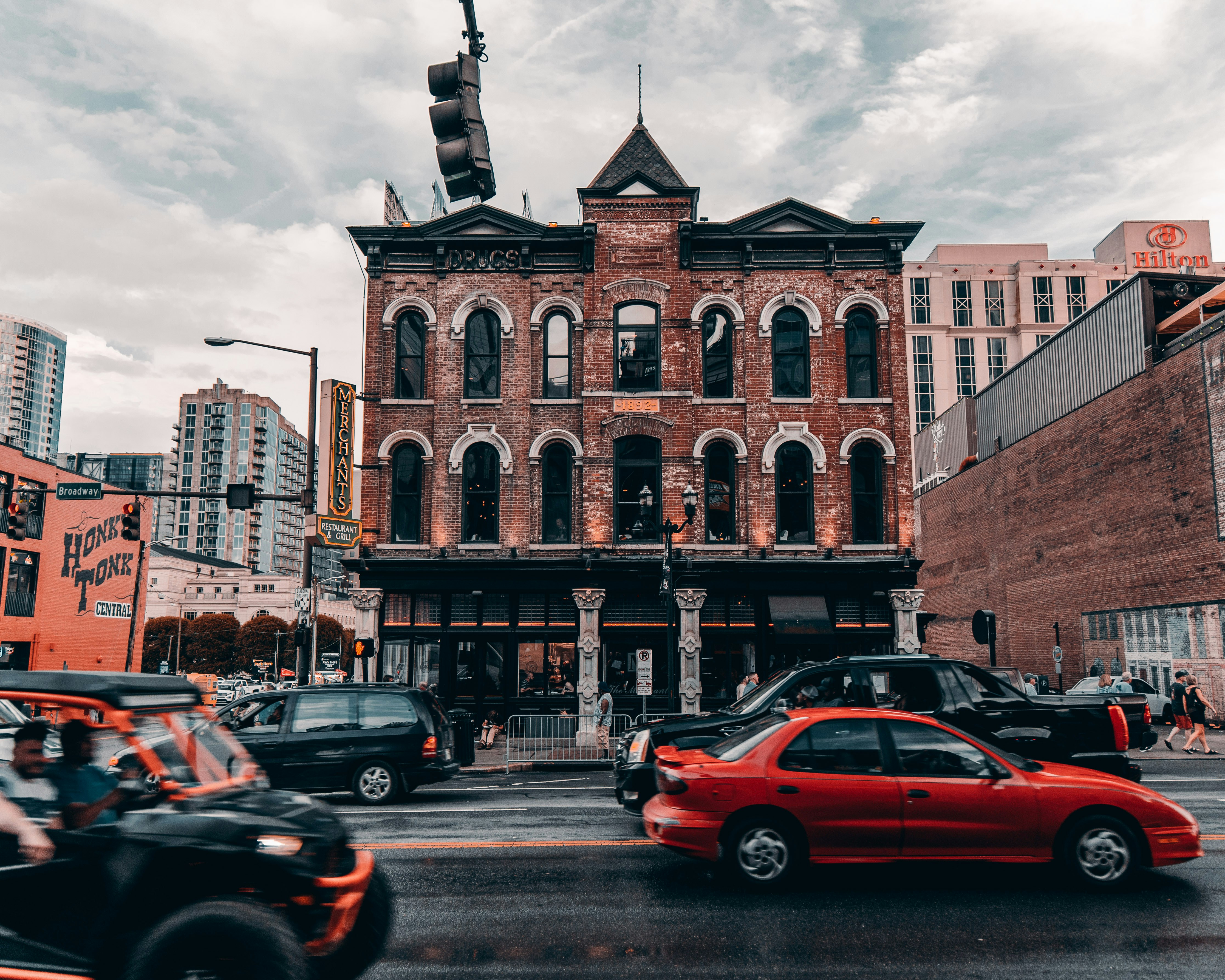 cars parked in front of brown building