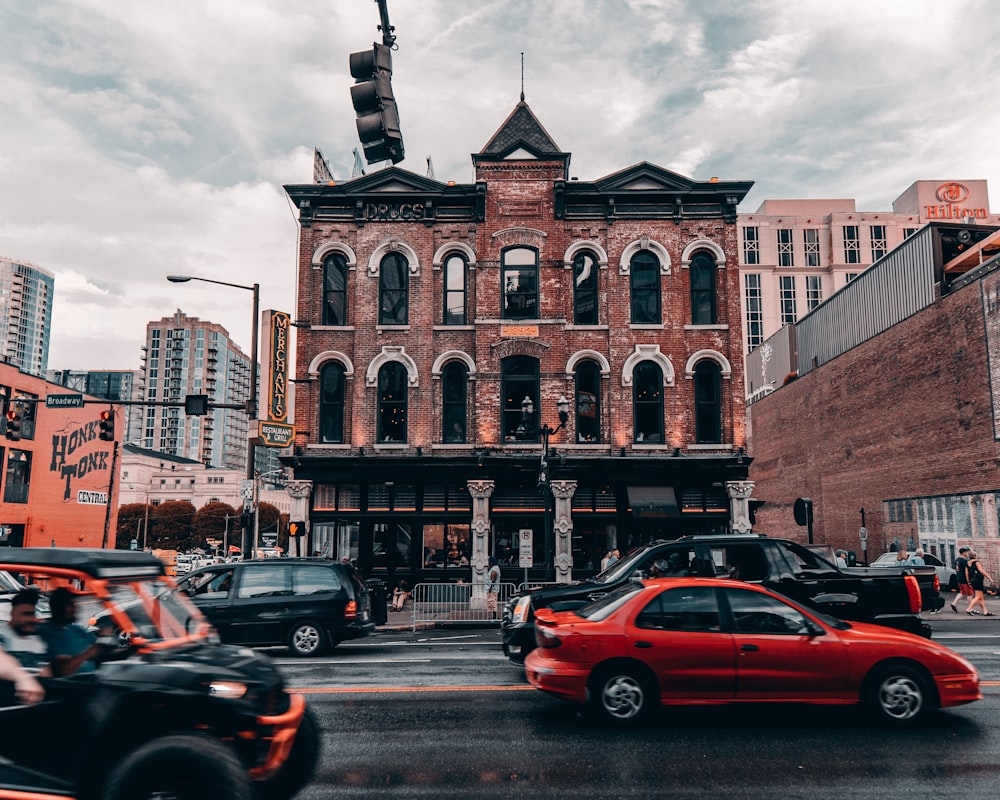 cars parked in front of brown building