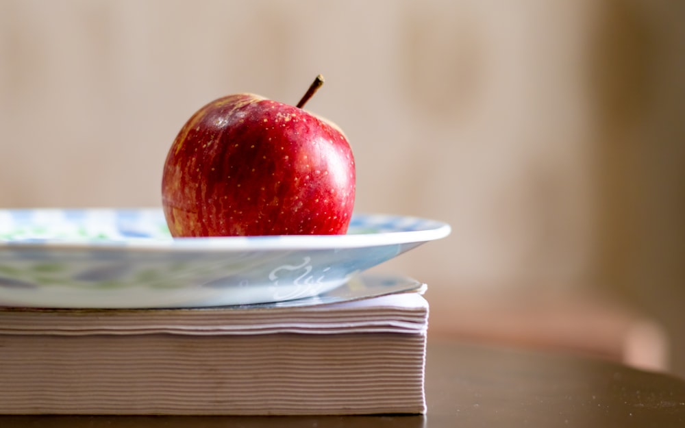 red apple fruit on white ceramic plate