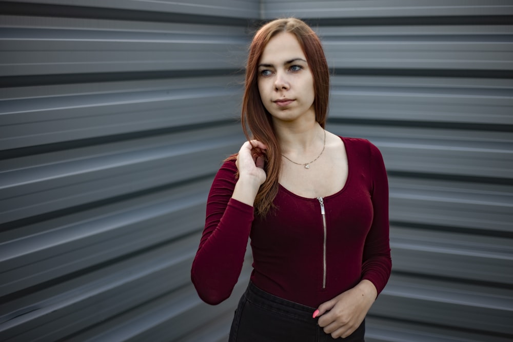 woman in red long sleeve shirt and black skirt