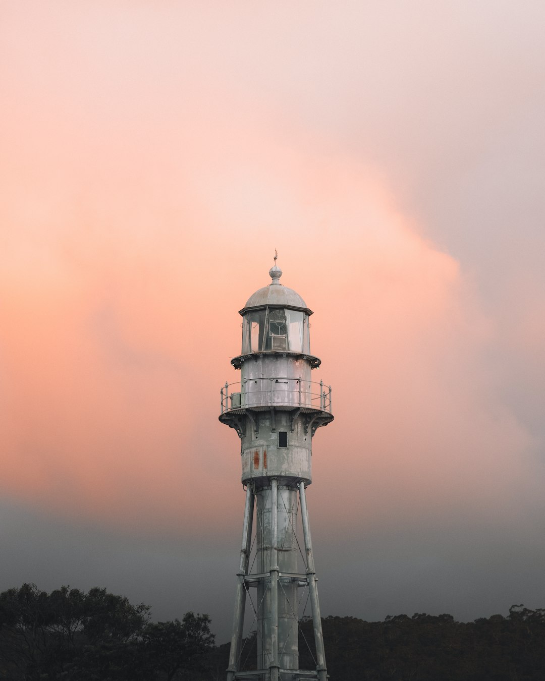white and black lighthouse under orange sky