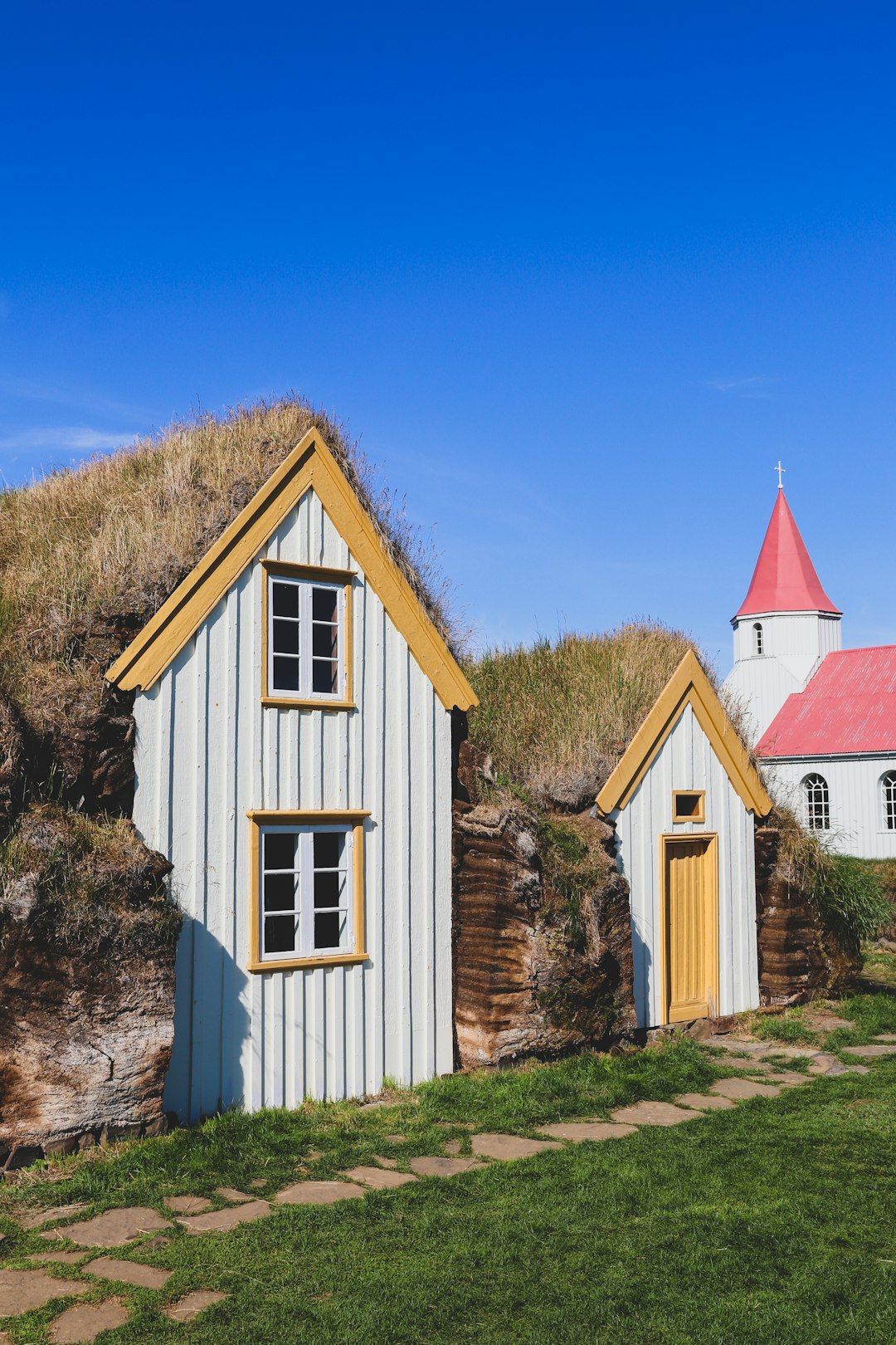 white and brown wooden house on hill