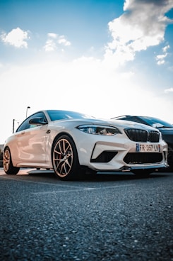 A shiny, freshly detailed car parked under a bright blue sky showcasing its gleaming surface.