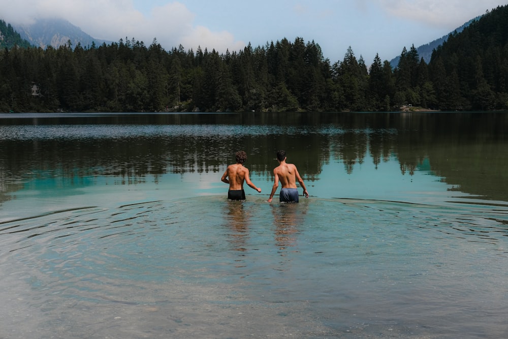 2 women in body of water during daytime