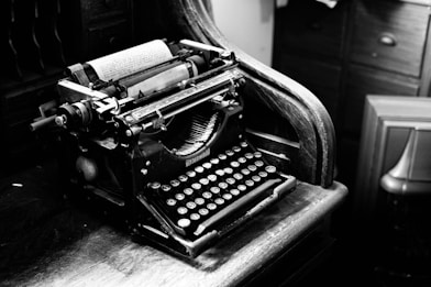 black and gray typewriter on table
