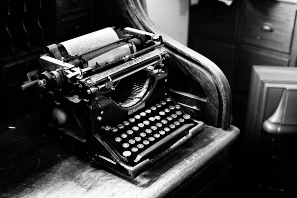 A vintage facsimile machine from the 1980s resting on a wooden desk, surrounded by old newspapers and technical manuals.