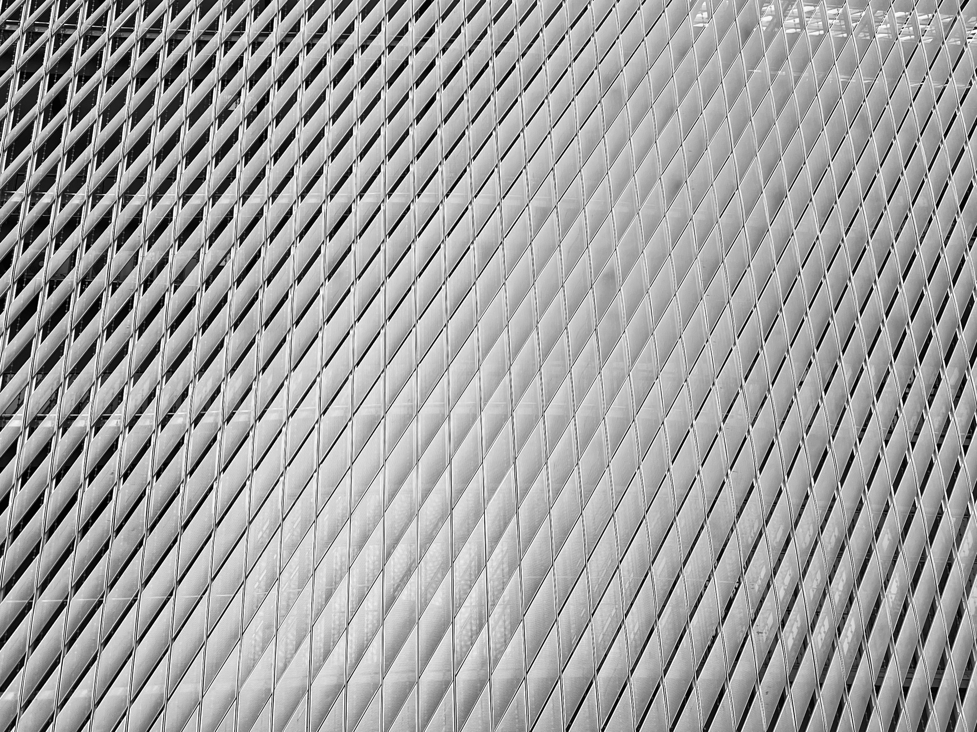 Stainless steel laser cut architectural facade panel with geometric diamond pattern, modern building exterior, polished silver surface