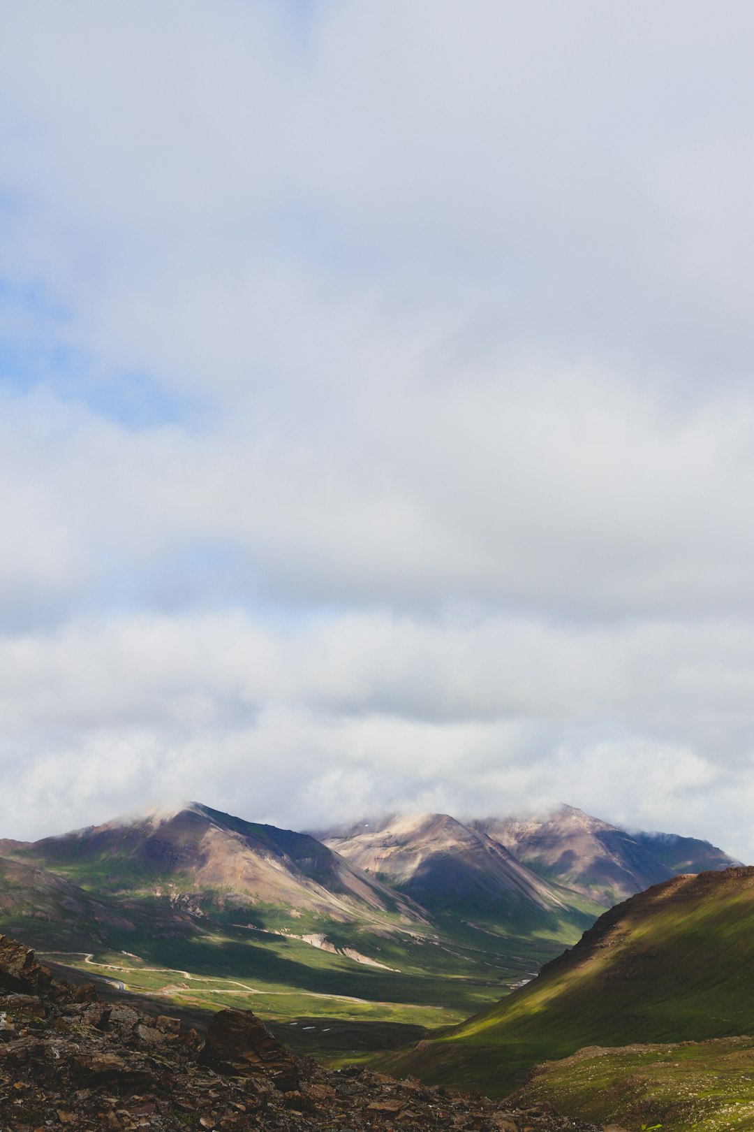 green and brown mountains under white clouds during daytime