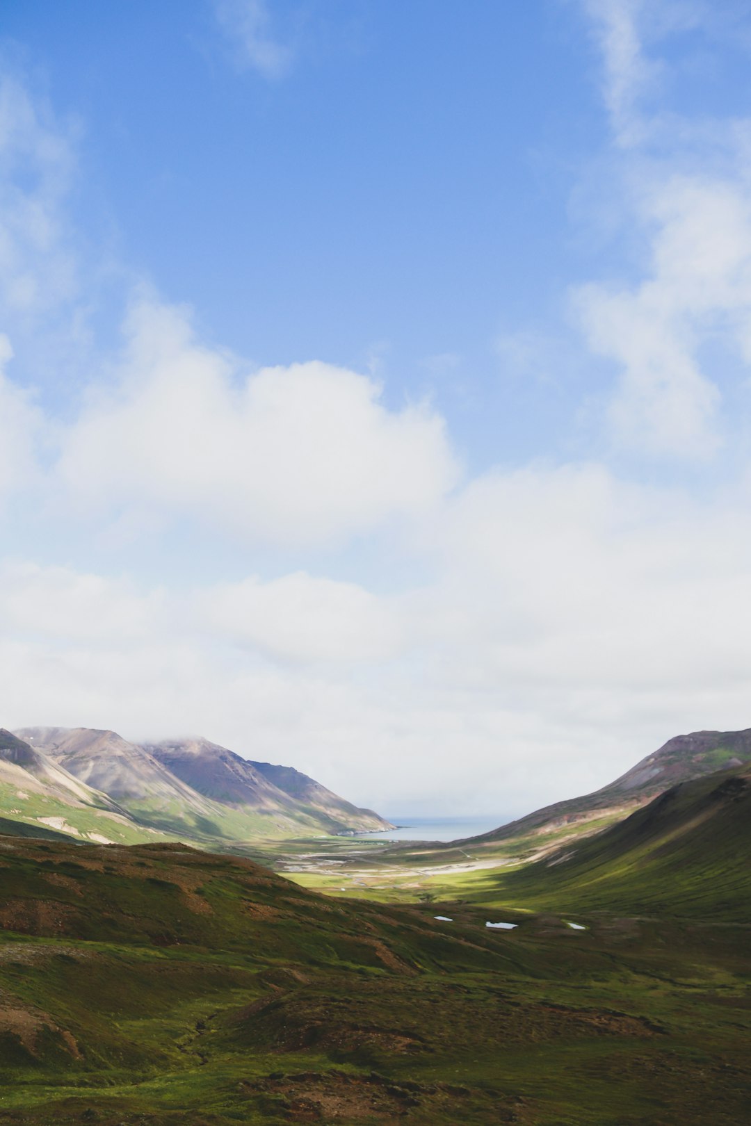 green mountains under white clouds during daytime