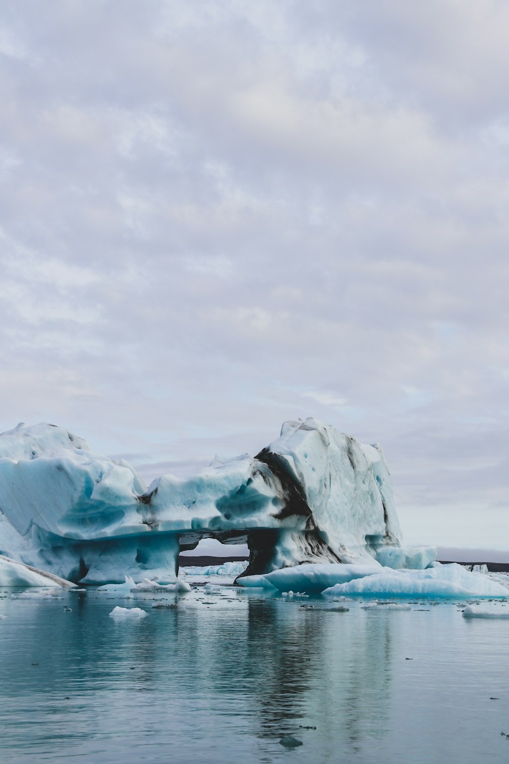 ice formation on body of water under white clouds