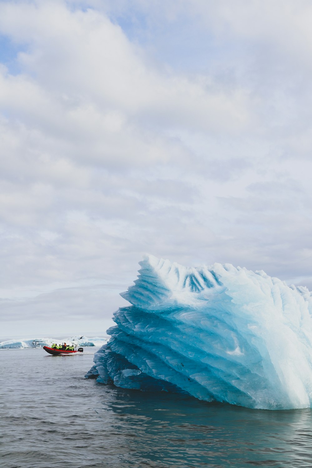 white and blue boat on sea water