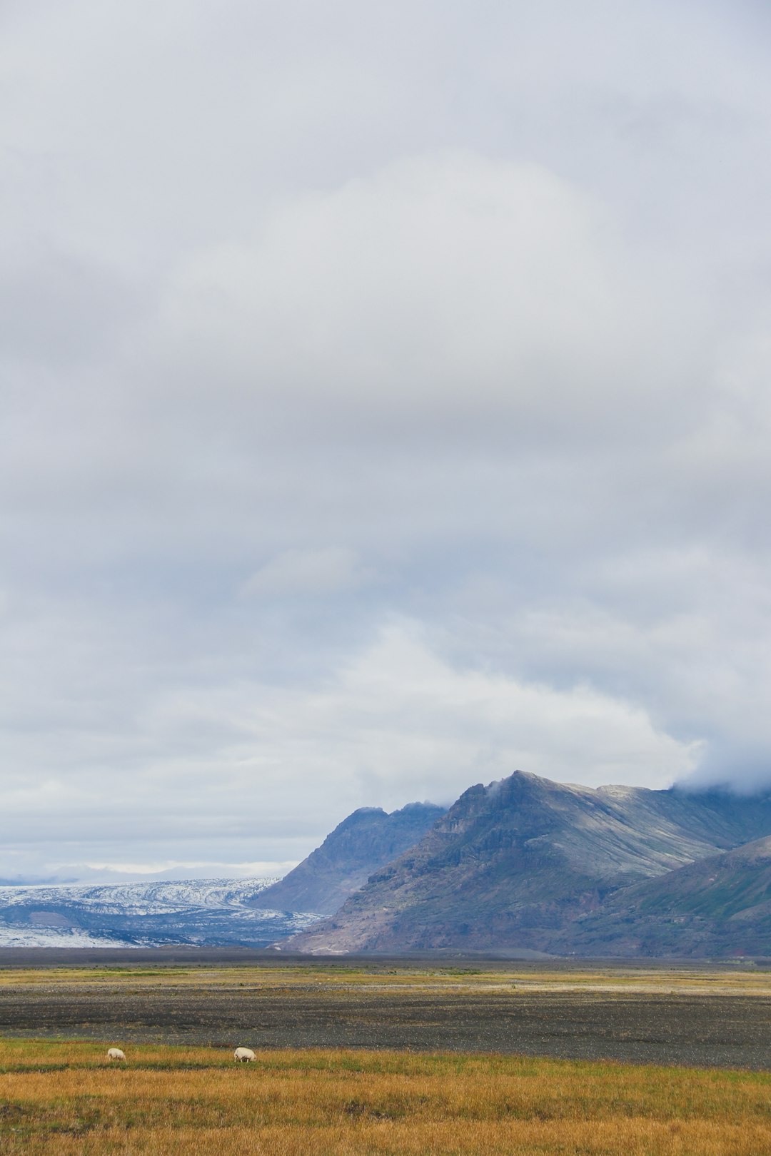 snow covered mountain under cloudy sky during daytime