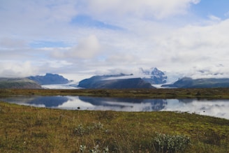 A serene landscape of Glacier Park with lush greenery and mountains in the background.