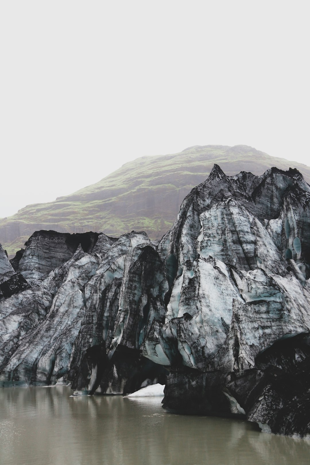 gray and green mountain under white sky during daytime