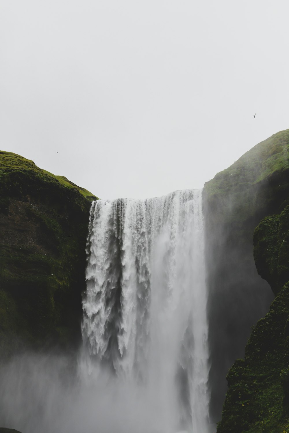 waterfalls on green and brown mountain