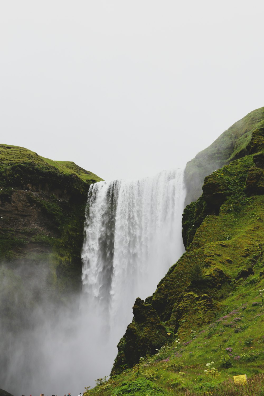 waterfalls on green grass covered hill during daytime