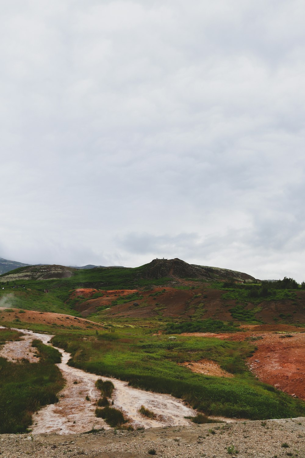 green and brown mountain under white clouds during daytime