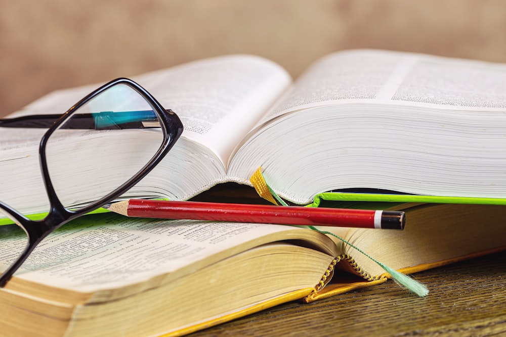 black framed eyeglasses on book page