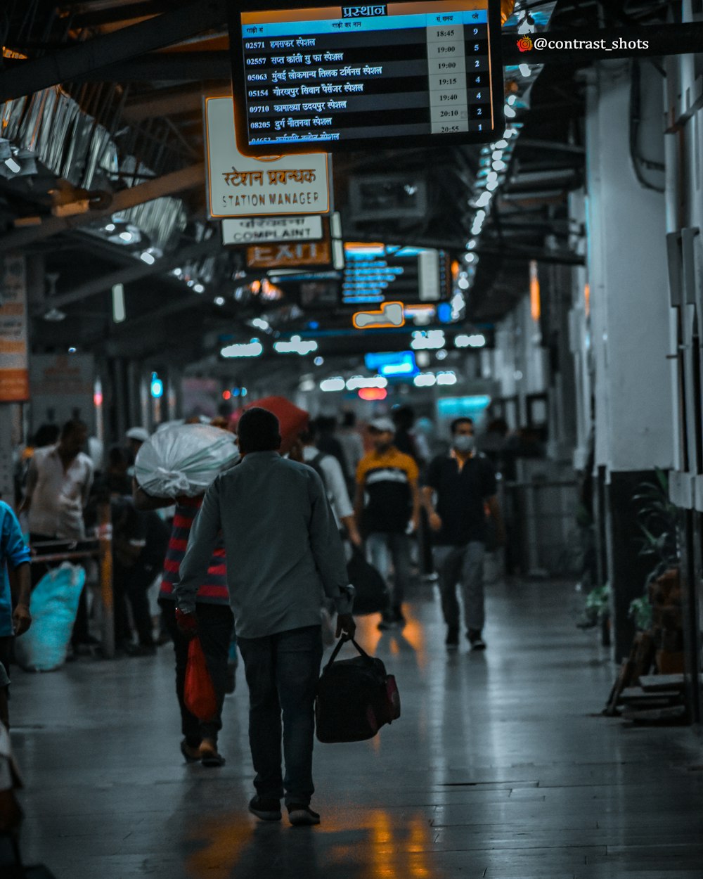 people walking on sidewalk during night time