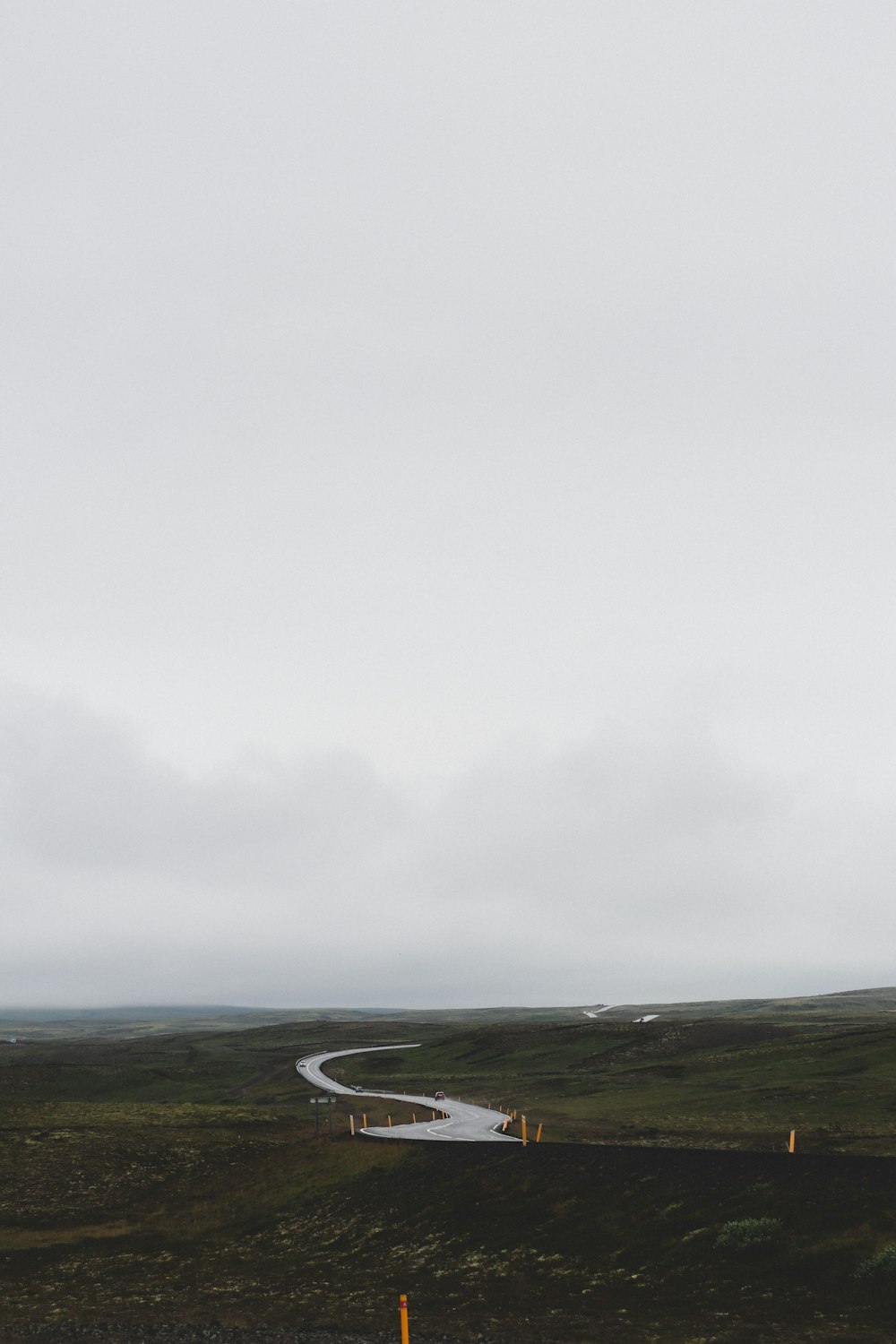 black asphalt road under white cloudy sky during daytime