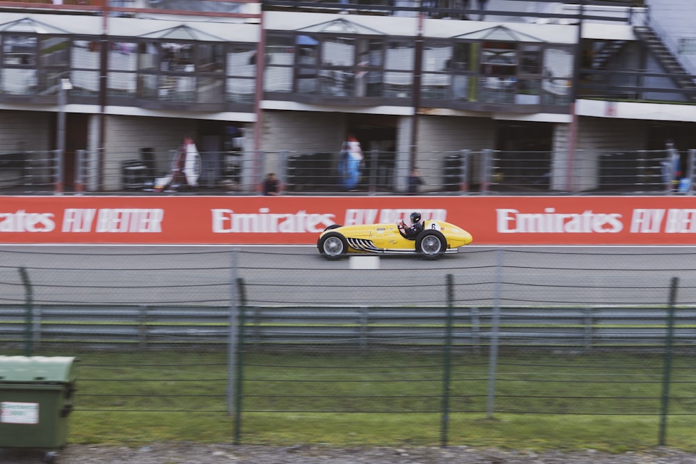 yellow and black racing car on road during daytime