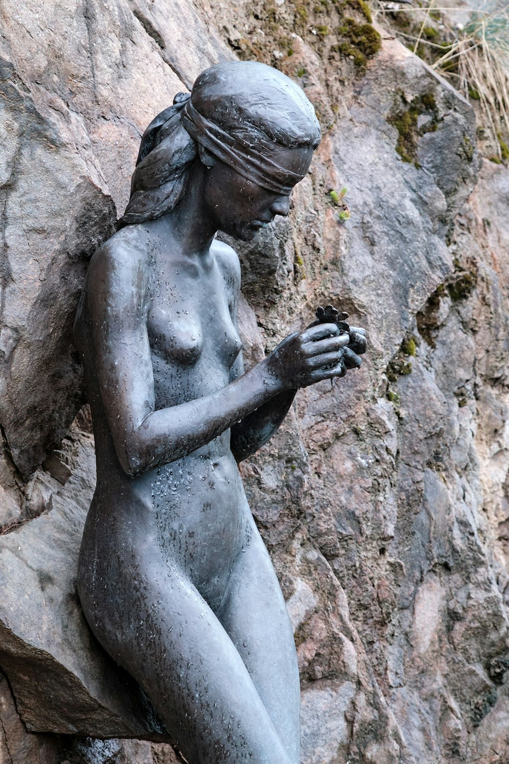 woman statue on brown rock