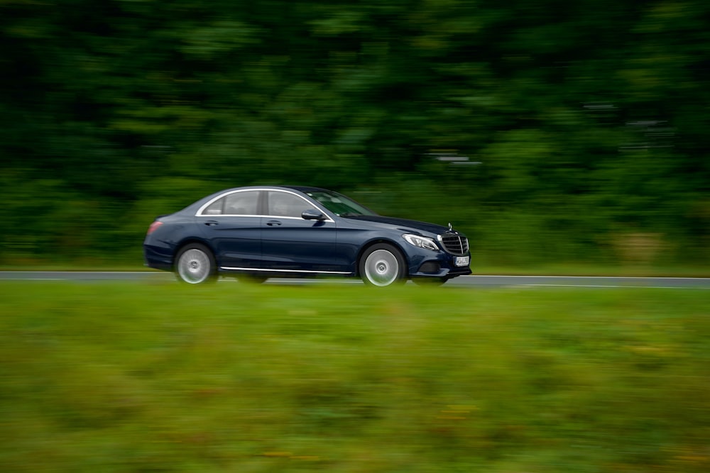 black coupe on green grass field during daytime