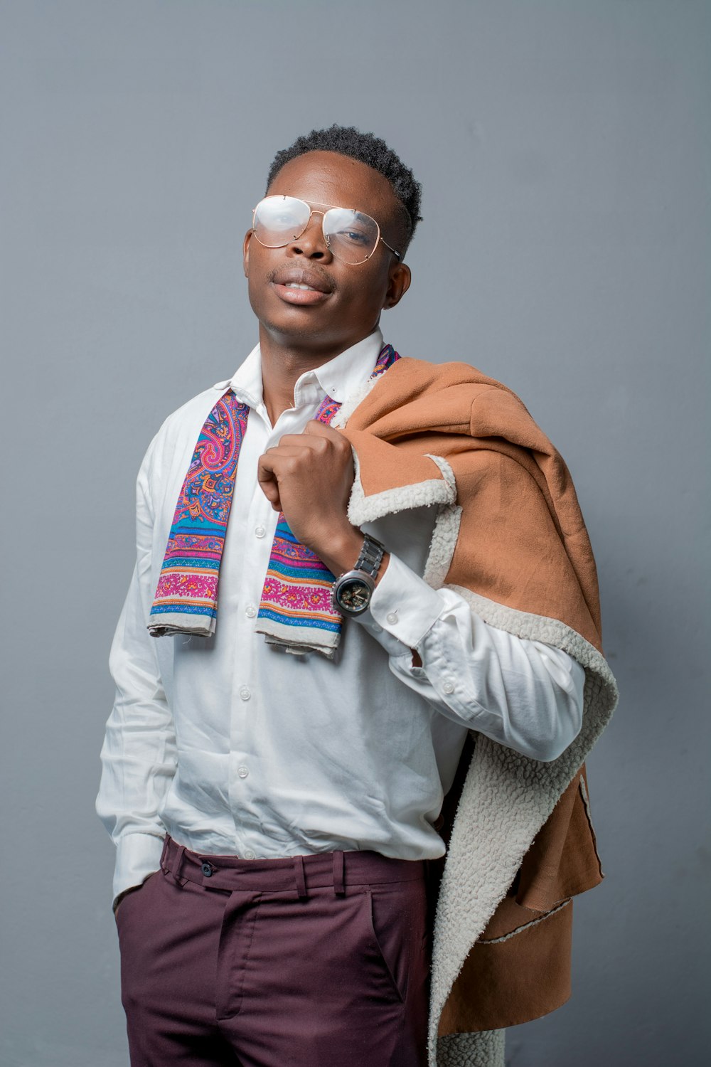 man in white dress shirt and orange vest wearing sunglasses