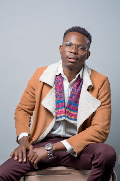 man in brown coat and white shirt