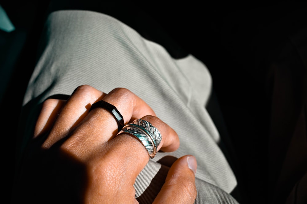 silver ring on persons ring finger