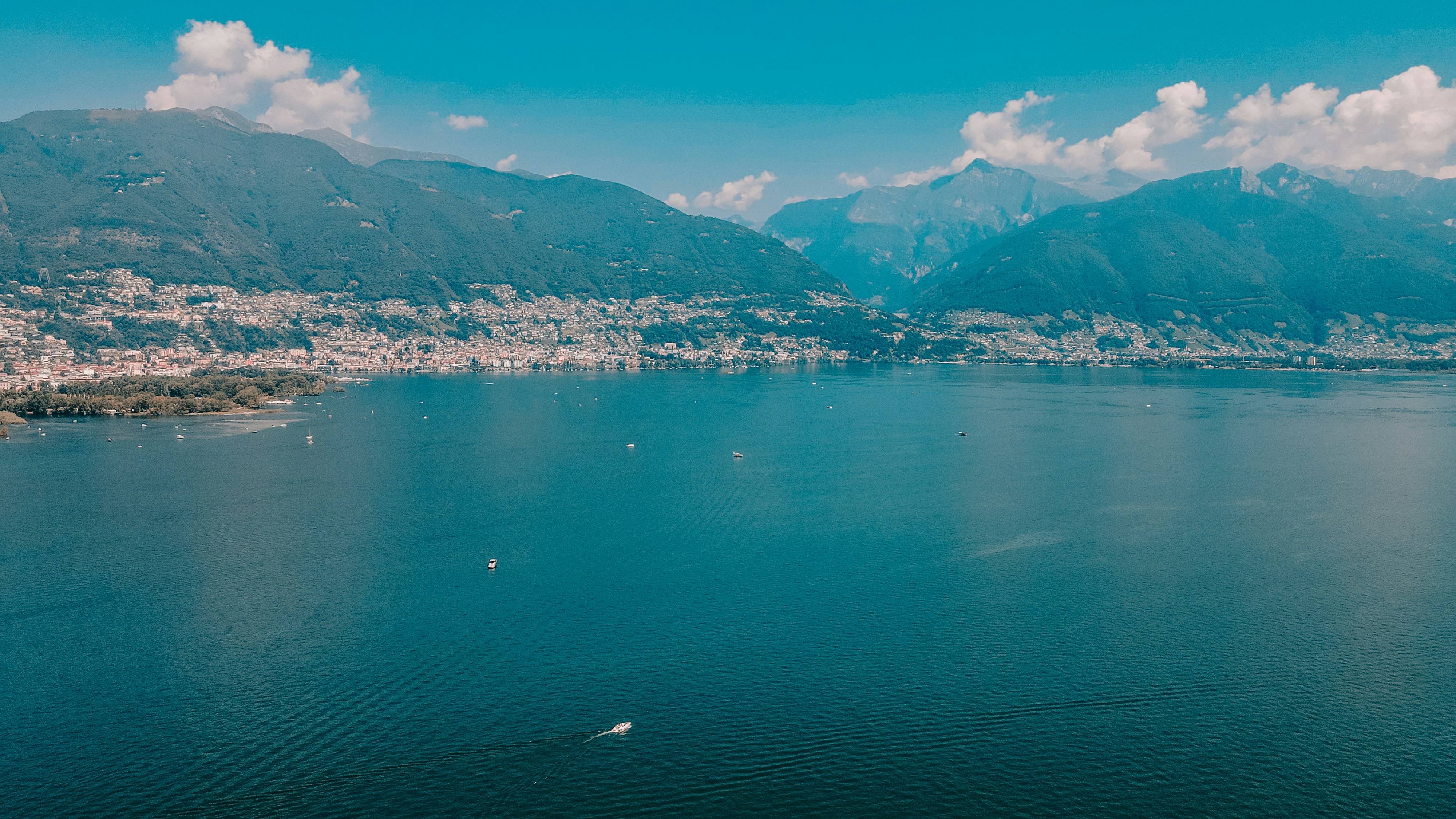 body of water near mountain during daytime