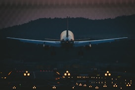 white airplane in the sky during night time