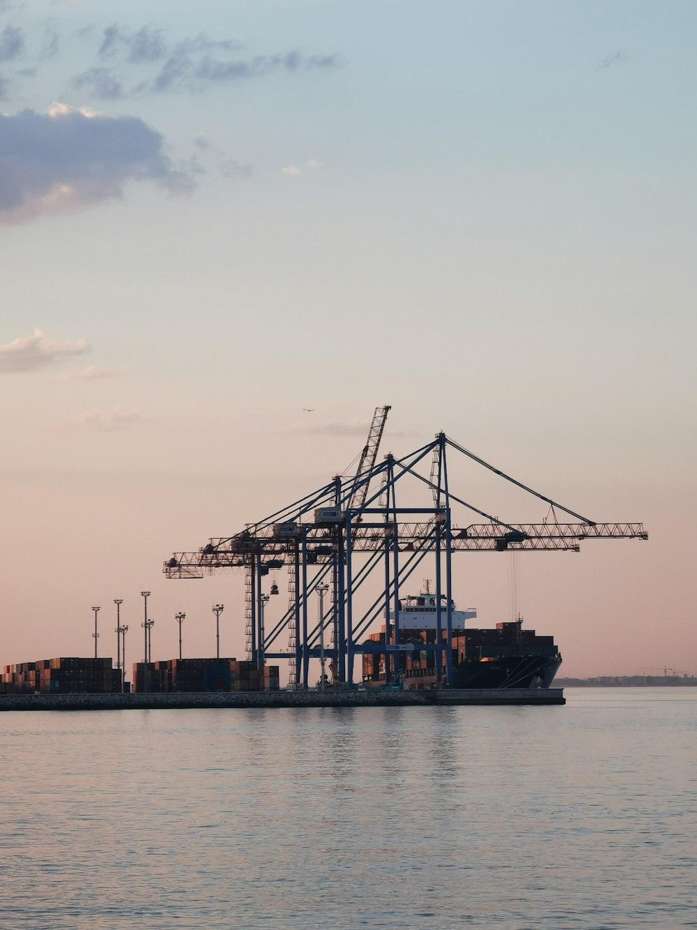 blue cargo ship on sea during daytime