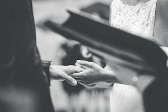 grayscale photo of person holding hands