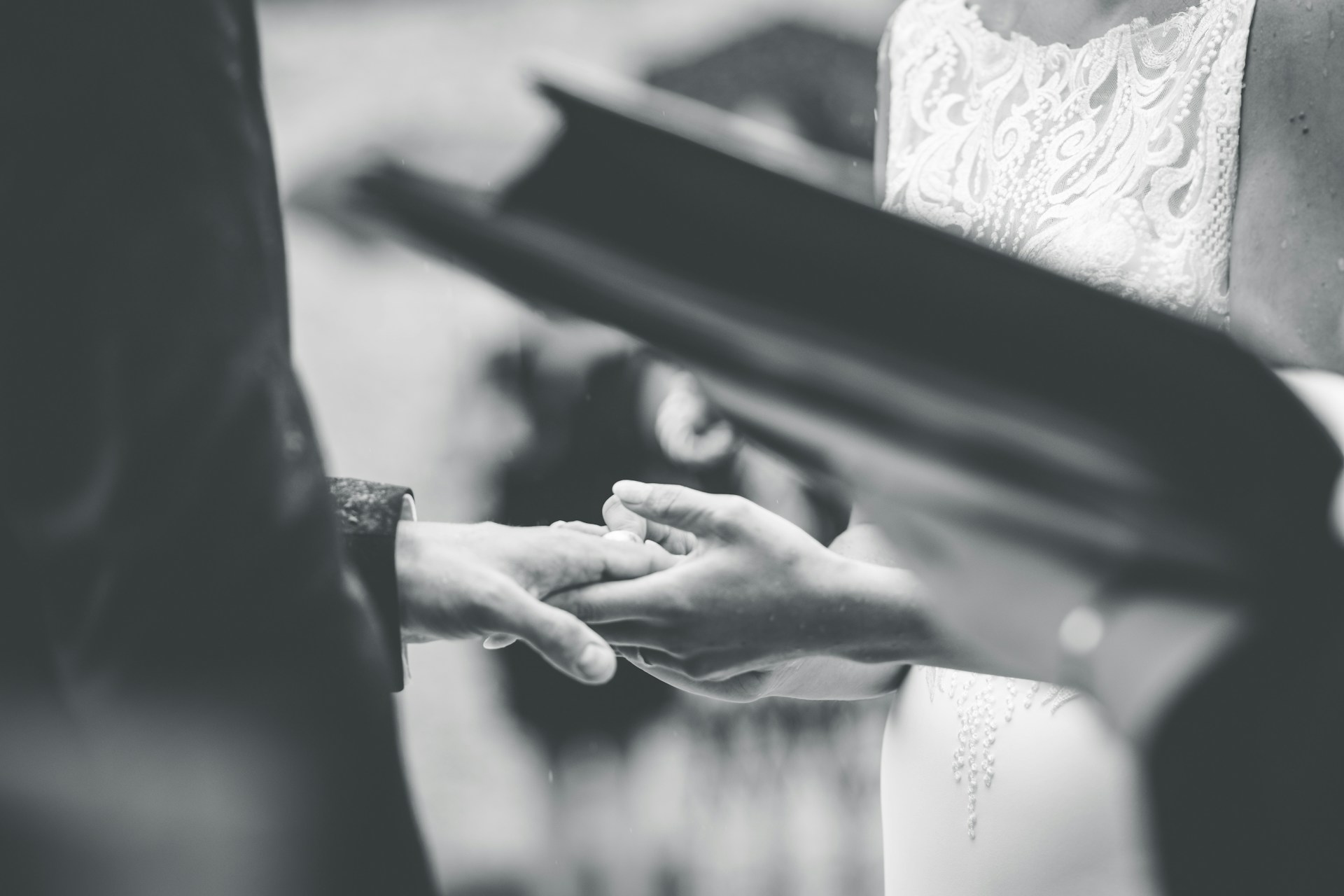 grayscale photo of person holding hands