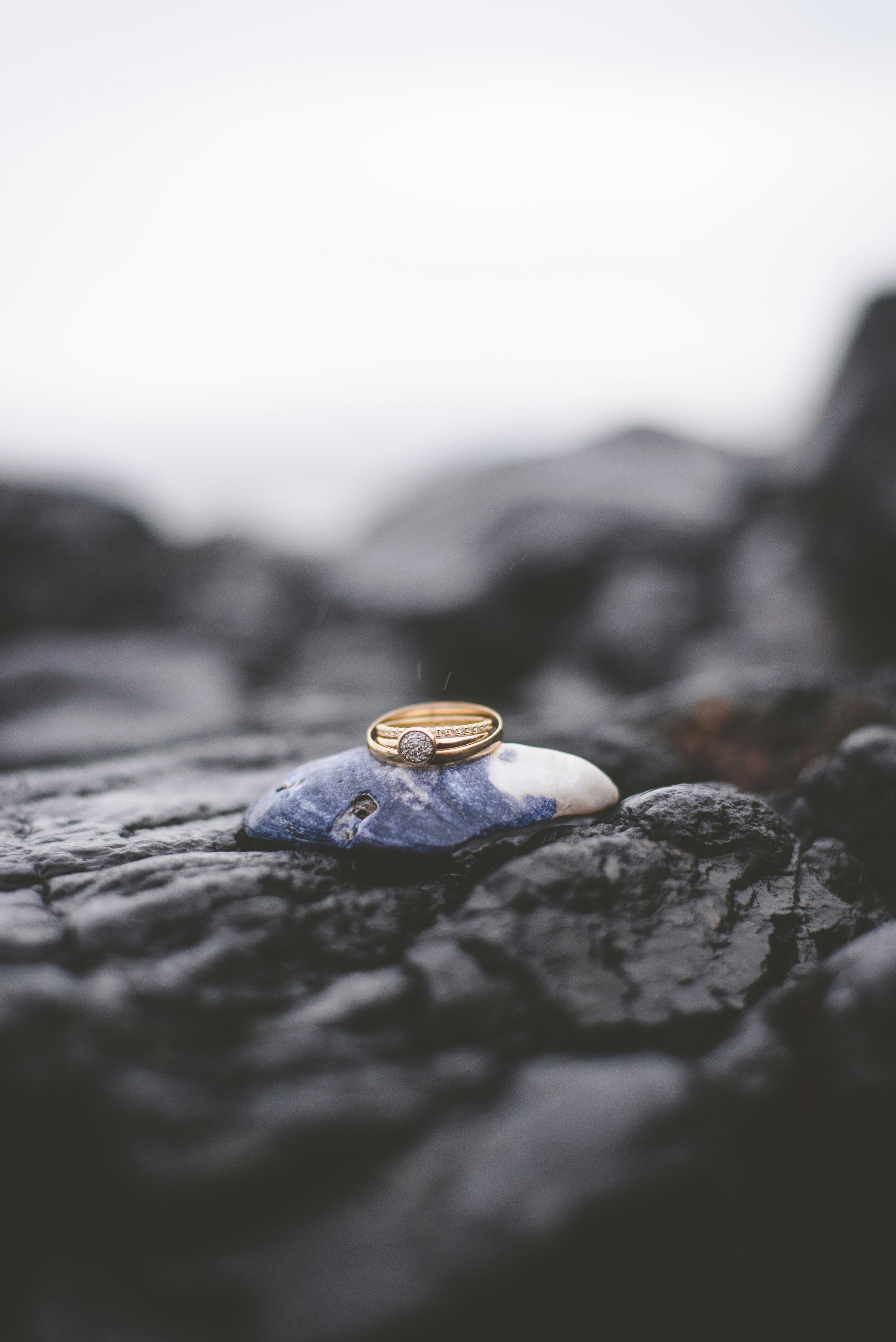 gold ring on black rock