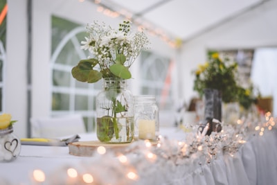 white flowers in clear glass vase on table