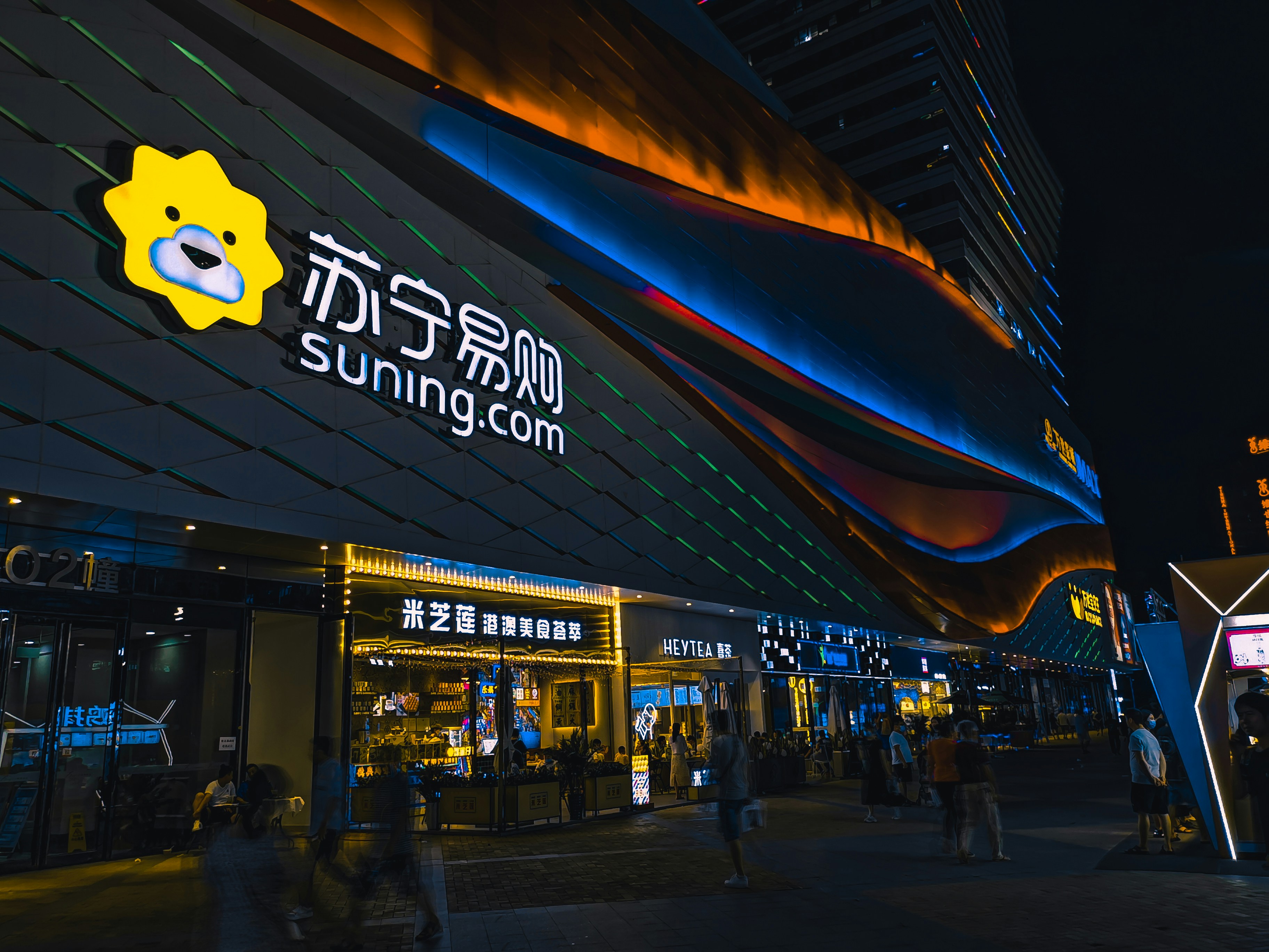 people walking on sidewalk during night time
