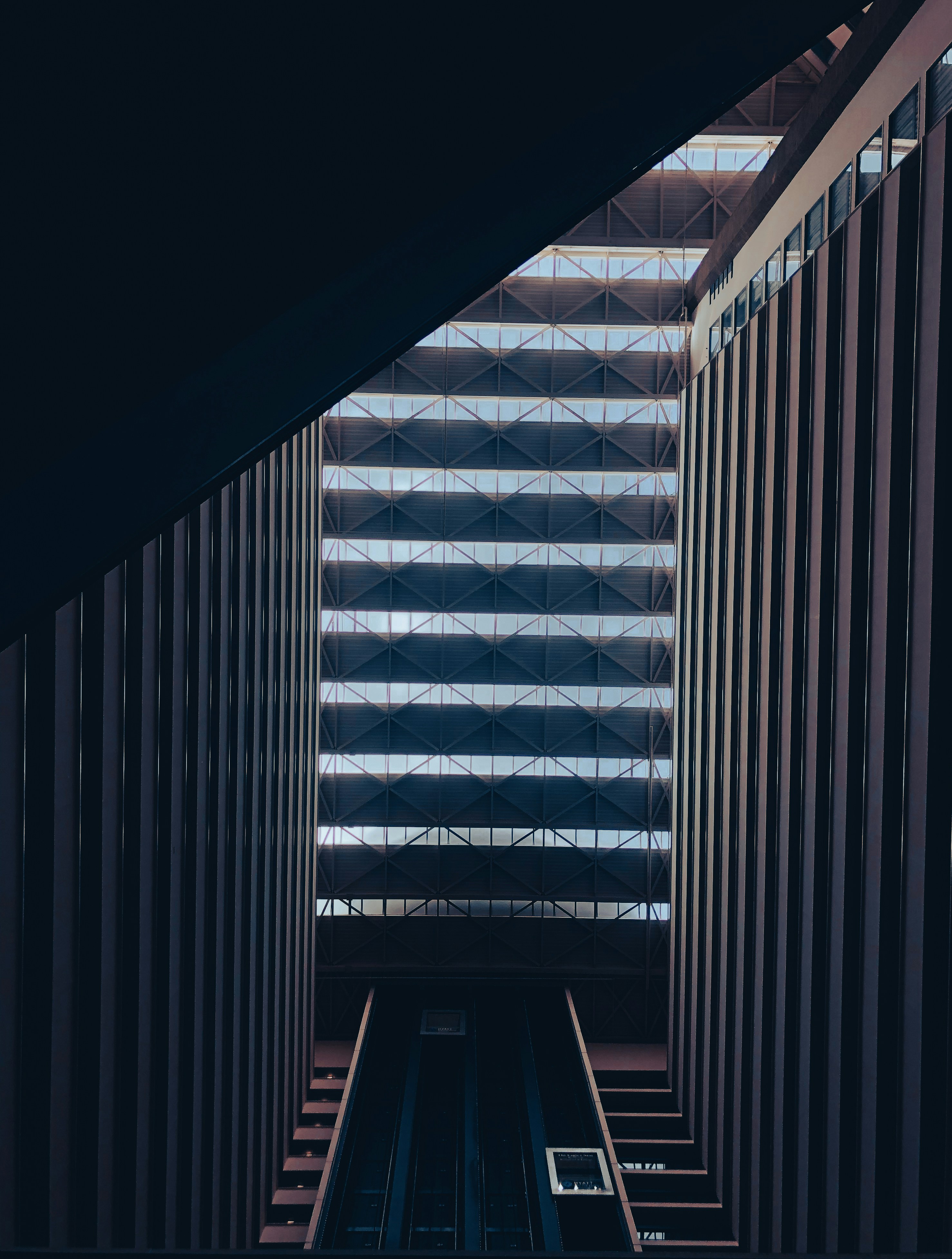 Abstract dark architectural interior with geometric shapes and warm accent lighting