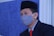 man in black suit wearing white face mask
