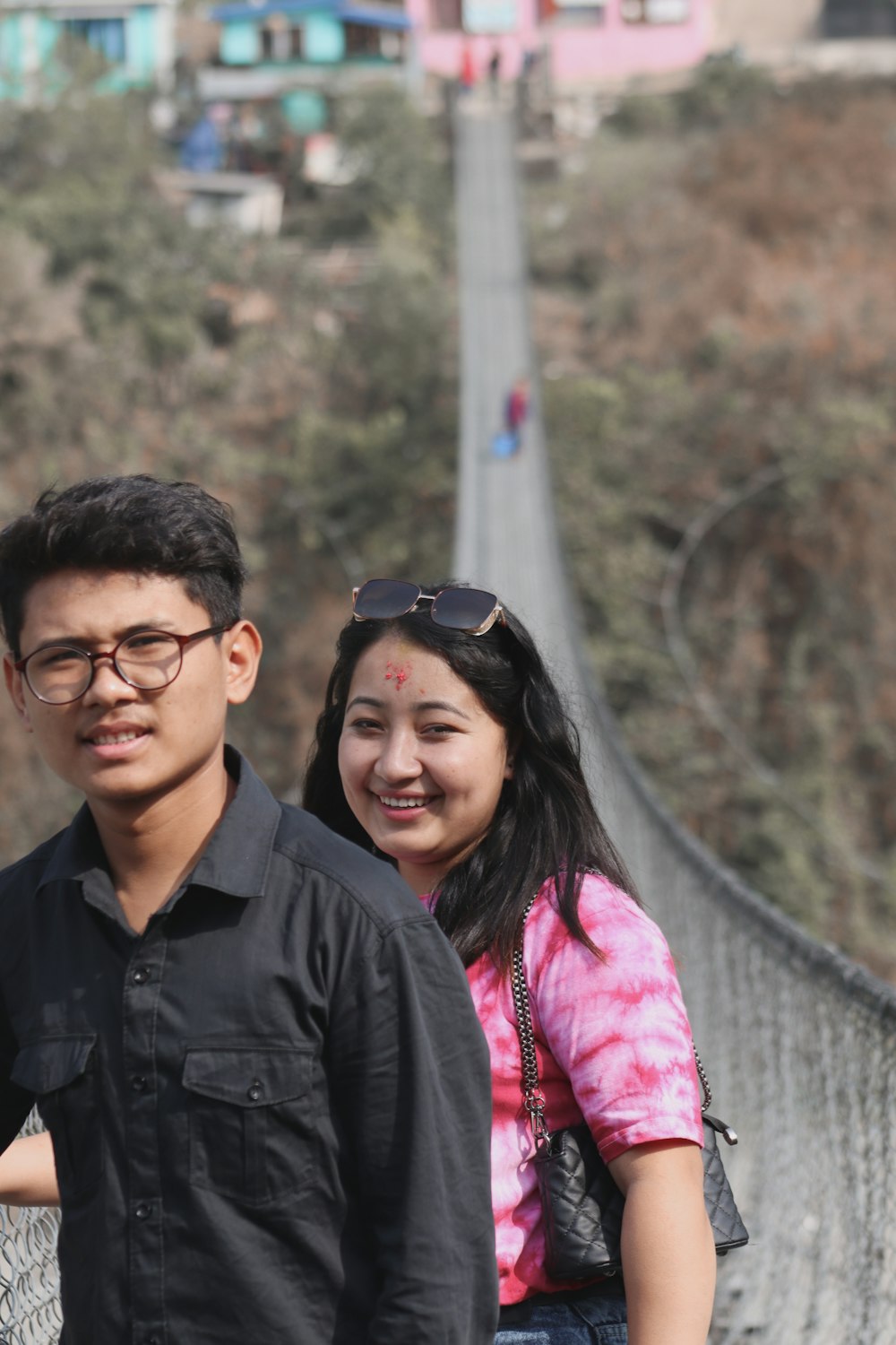 man in black button up shirt beside woman in pink jacket