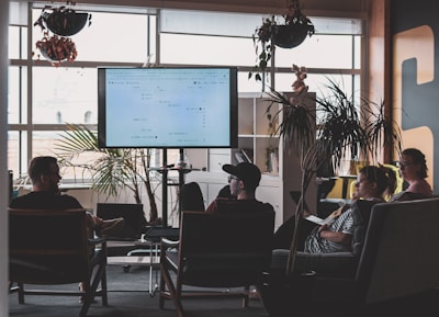 man in black shirt sitting on chair in front of computer monitor