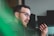 man in green shirt wearing black framed eyeglasses
