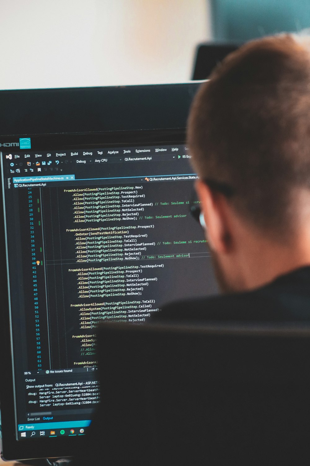 man in black shirt in front of computer monitor