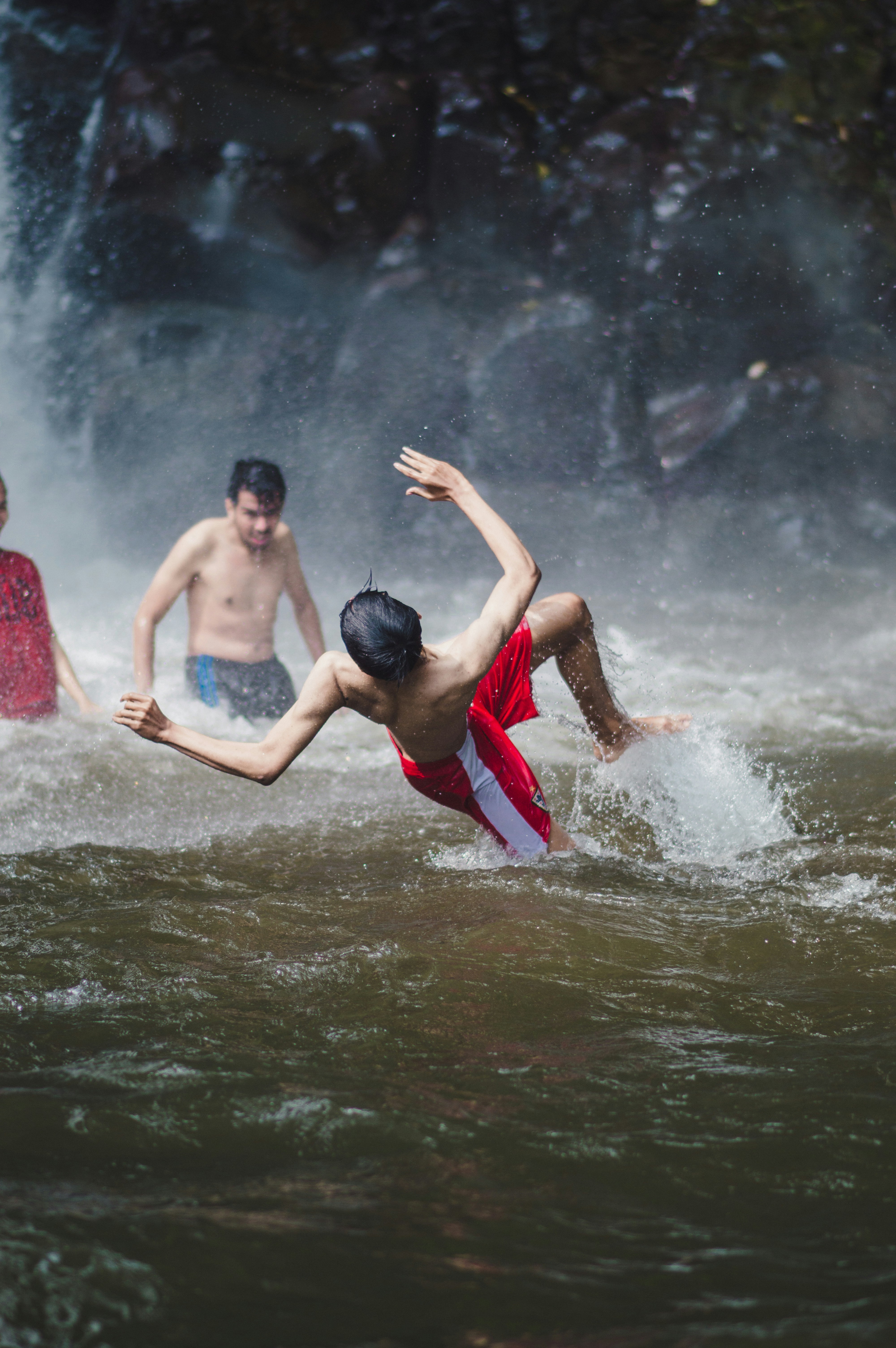 2 boys in red shorts on water during daytime
