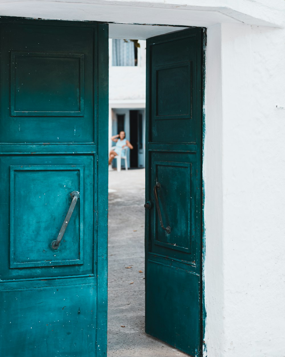 black wooden door with white wall