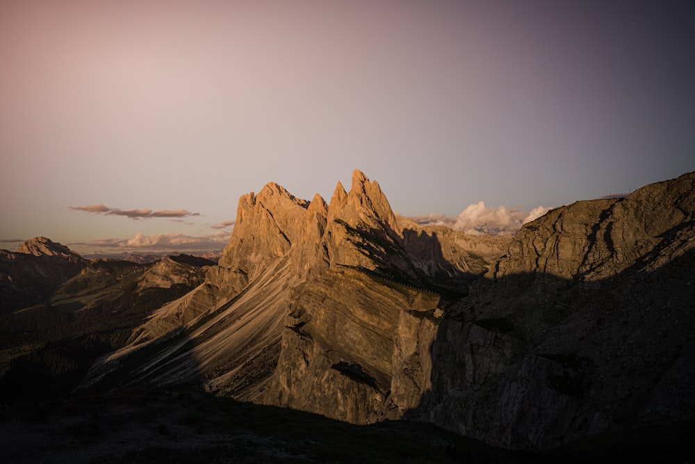 brown rocky mountain under gray sky